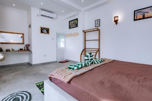a bedroom with a large bed with pillows on it at Madiha Ceylon Hotel in Matara