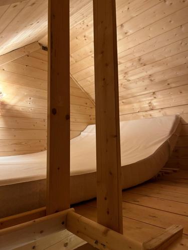 a room with two beds in a wooden cabin at U Pešků in Kožlí u Orlíka