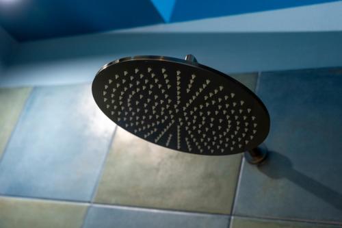 a black fan sitting on the floor in a bathroom at Iris Apartments in Monopoli