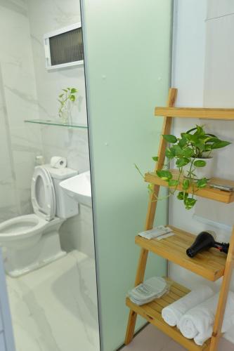 a bathroom with a toilet and a glass shower at Timmy's house in Ho Chi Minh City