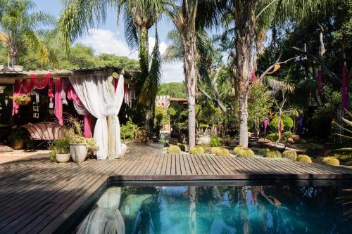 a wedding venue with a swimming pool and palm trees at The Art Guesthouse in Hartbeespoort