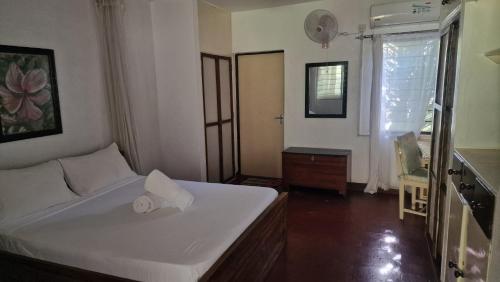a bedroom with a bed and a dresser and a window at Boma Banda Diani - Kaskazi Cottage in Diani Beach