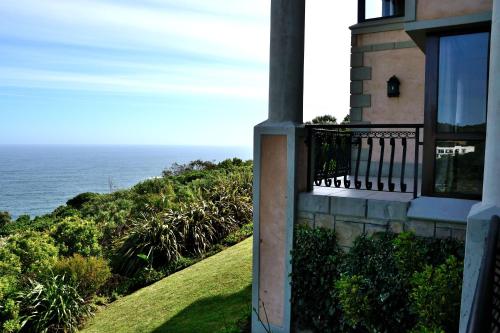 a balcony of a house with the ocean in the background at Villa Seaview in Knysna