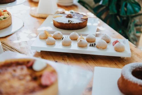 a table topped with cakes and pastries on plates at Masseria Torrepietra in Monopoli