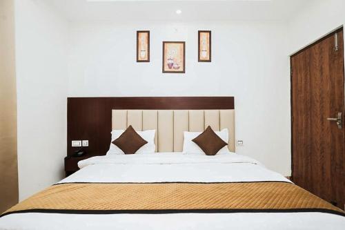 a bedroom with a large bed with a wooden headboard at Hotel The 7 Seas in Rishīkesh