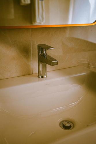 a sink with a faucet on top of it at Villa Golf Novaworld in Bình Sum