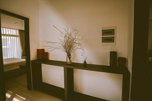 a shelf in a room with a vase on it at Villa Golf Novaworld in Bình Sum