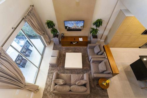 an overhead view of a living room with a tv at Gorgeous 4 Bd Close to Disney @ Magic Village 3114 in Orlando