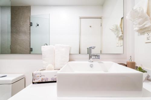 a white bathroom with a sink and a bath tub at Casa Flor Cabo Your Private Oasis in Cabo San Lucas