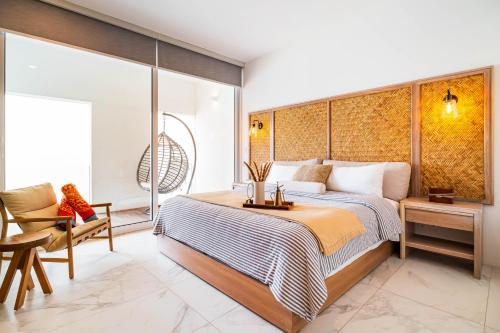 a bedroom with a king sized bed and a chair at Casa Flor Cabo Your Private Oasis in Cabo San Lucas