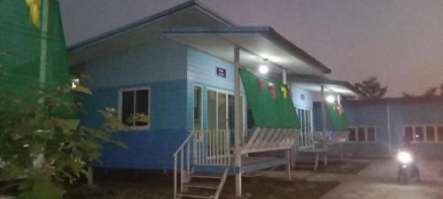 a building with a bench in front of it at night at Hardrock open house chiang rai thai in Ban Den