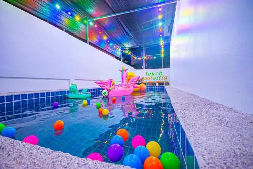 a pool with colorful balls in a swimming pool at Soi 15 Thappraya Pool villa- 5km to Jomtien beach in Pattaya