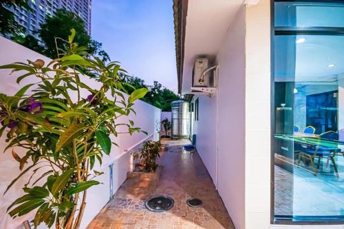 a corridor of a building with potted plants at Soi 15 Thappraya Pool villa- 5km to Jomtien beach in Pattaya