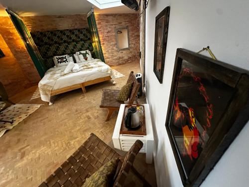 a living room with a bed and a couch at Mama Souiri Hotel in Essaouira