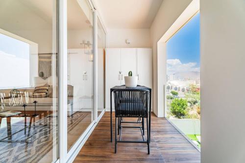a dining room with a table and a large window at Casa Flor Cabo Your Private Oasis in Cabo San Lucas