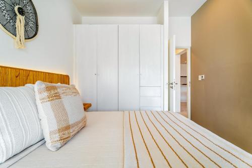 a bedroom with a bed with a clock on the wall at Casa Flor Cabo Your Private Oasis in Cabo San Lucas