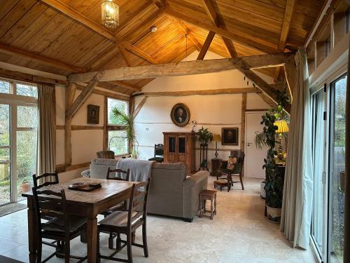 a living room with a table and a couch at The Barn in Romsey
