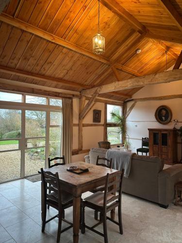 a living room with a table and a couch at The Barn in Romsey