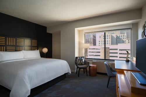 a hotel room with a bed and a window at Renaissance Des Moines Savery Hotel in Des Moines