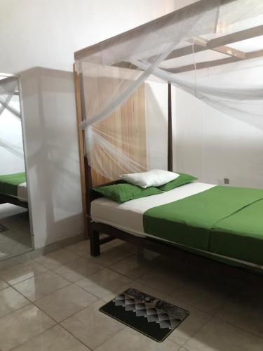 a bedroom with a bed with a canopy at Villa Sandamedura in Koggala
