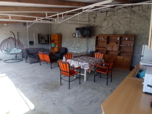 a living room with a table and chairs at CsászárLak Vendégház in Tarcal
