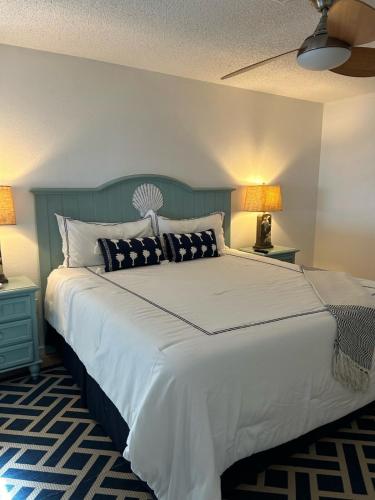 a bedroom with a large bed with two lamps at Private Bayfront Beach House with Dock, Steps to Beach and Restaurants in Englewood