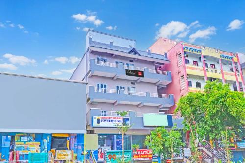 a tall building with balconies on the side of it at Collection O De Alphabet Hotel UMCC in Hyderabad
