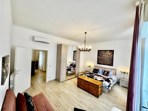 a bedroom with a bed and a chandelier at La casa di Sarah aspetta voi in Naples