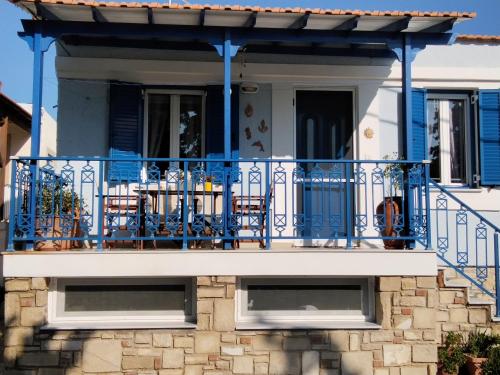 a blue balcony of a house with chairs on it at Dora's House in Chios