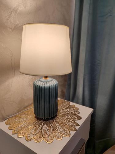 a lamp sitting on top of a table at Narva Vahtra Apartment in Narva