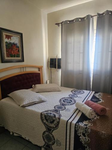 a bedroom with a bed and a window with curtains at Casa da bisa Élida in São Gabriel