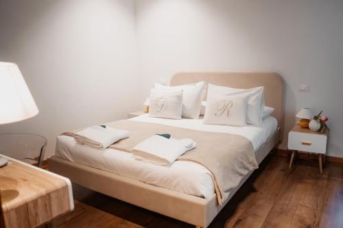 a bedroom with a bed with two towels on it at ILLASI DREAM ROOMS in Illasi