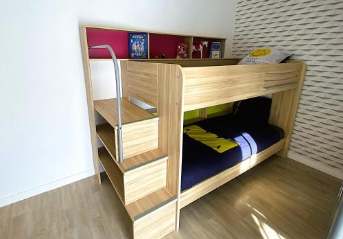 a wooden bunk bed in a room at L'instant d'un souvenir in Taupont