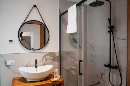 a bathroom with a sink and a shower at ILLASI DREAM ROOMS in Illasi