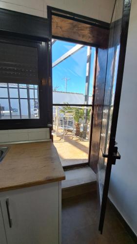 a kitchen with a window and a view of a patio at Las Eras 2 in Herencia