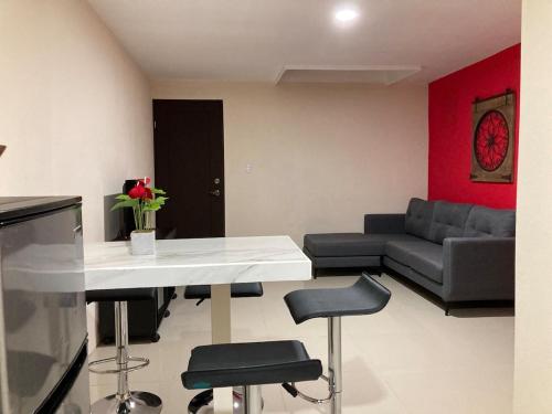 a living room with a table and chairs and a couch at Hospedaje Ana Lu 3, Only 10 minutes from airport, in Alajuela City