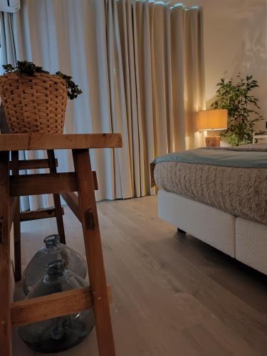 a bedroom with a bed and a chair and a table at B&B Intilia in Kortrijk