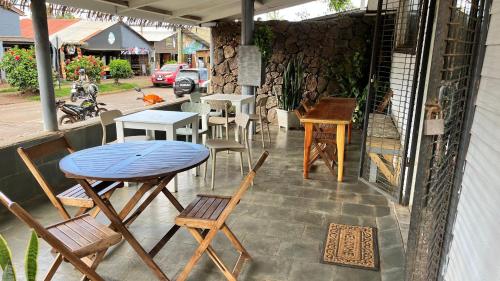 a group of tables and chairs on a patio at Inaki Uhi Hotel in Hanga Roa