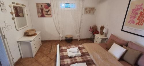 a living room with a couch and a mirror at Kineta Farmhouse in Kineta