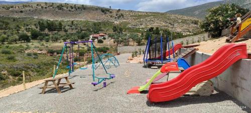 a group of playground equipment in at Kineta Farmhouse in Kineta