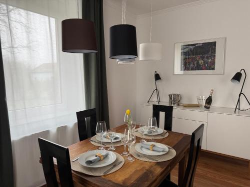 a dining room with a wooden table with chairs at Historie trifft Moderne in Weikersheim