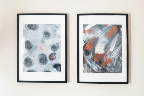 two pieces of art hanging on a wall at Smart & Cozy Apartment - Balkon, Netflix, Nespresso in Chemnitz