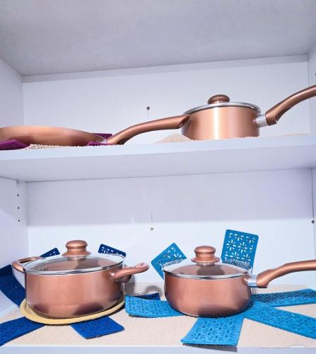 two pots sitting on a shelf in a kitchen at Welcome to your Serene Gateway in London