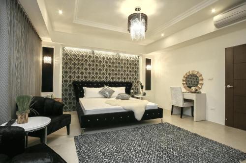 a bedroom with a bed and a couch and a table at 宜蘭小綠丘民宿 in Luodong