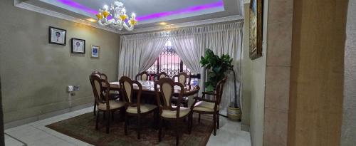 a dining room with a table and chairs and a window at Nature's Retreat in Willowdene