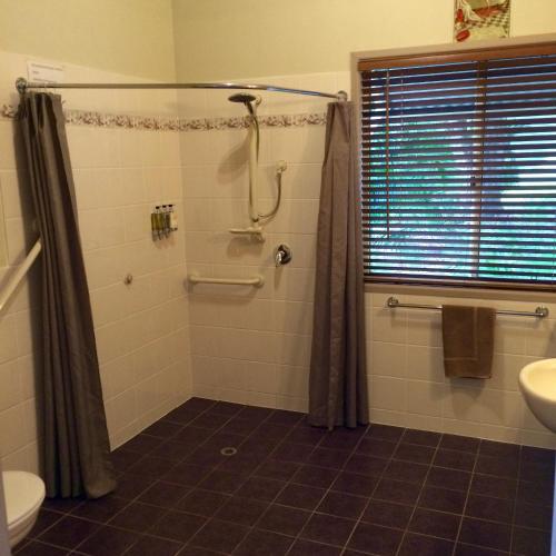 a bathroom with a shower and a sink at Maleny Luxury Cottages in Maleny