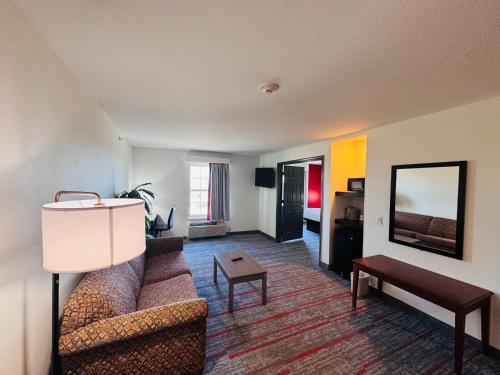 a living room with a couch and a table at Ramada by Wyndham Sparta/At Speedway in Sparta