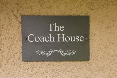 a sign that says the coach house on a wall at The Coach House in Stirling