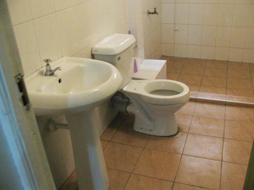 a bathroom with a toilet and a sink at Lulu's Guest House in Nairobi
