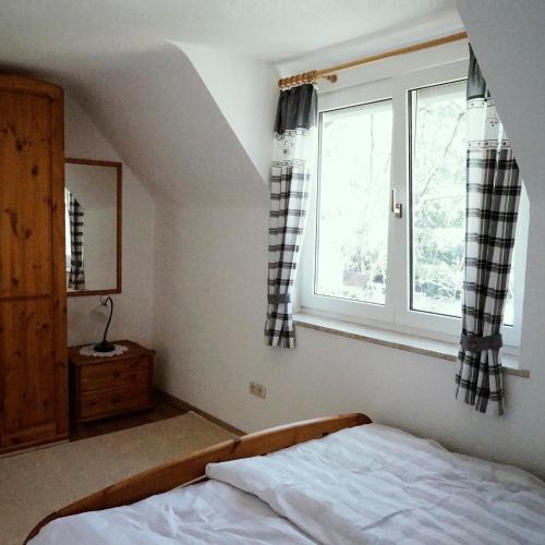 a bedroom with a bed and a window at Ferienhof am Ipf in Bopfingen